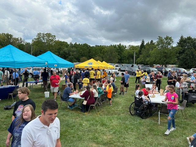 Guests and volunteers under the tents at the VIP Carnival