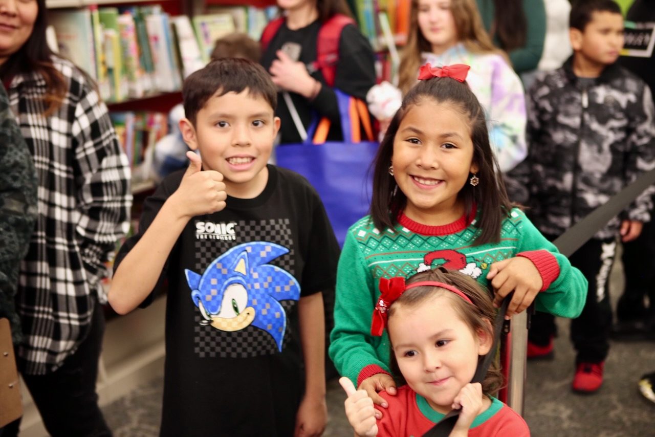 Three children giving a thumbs up at VIP Christmas