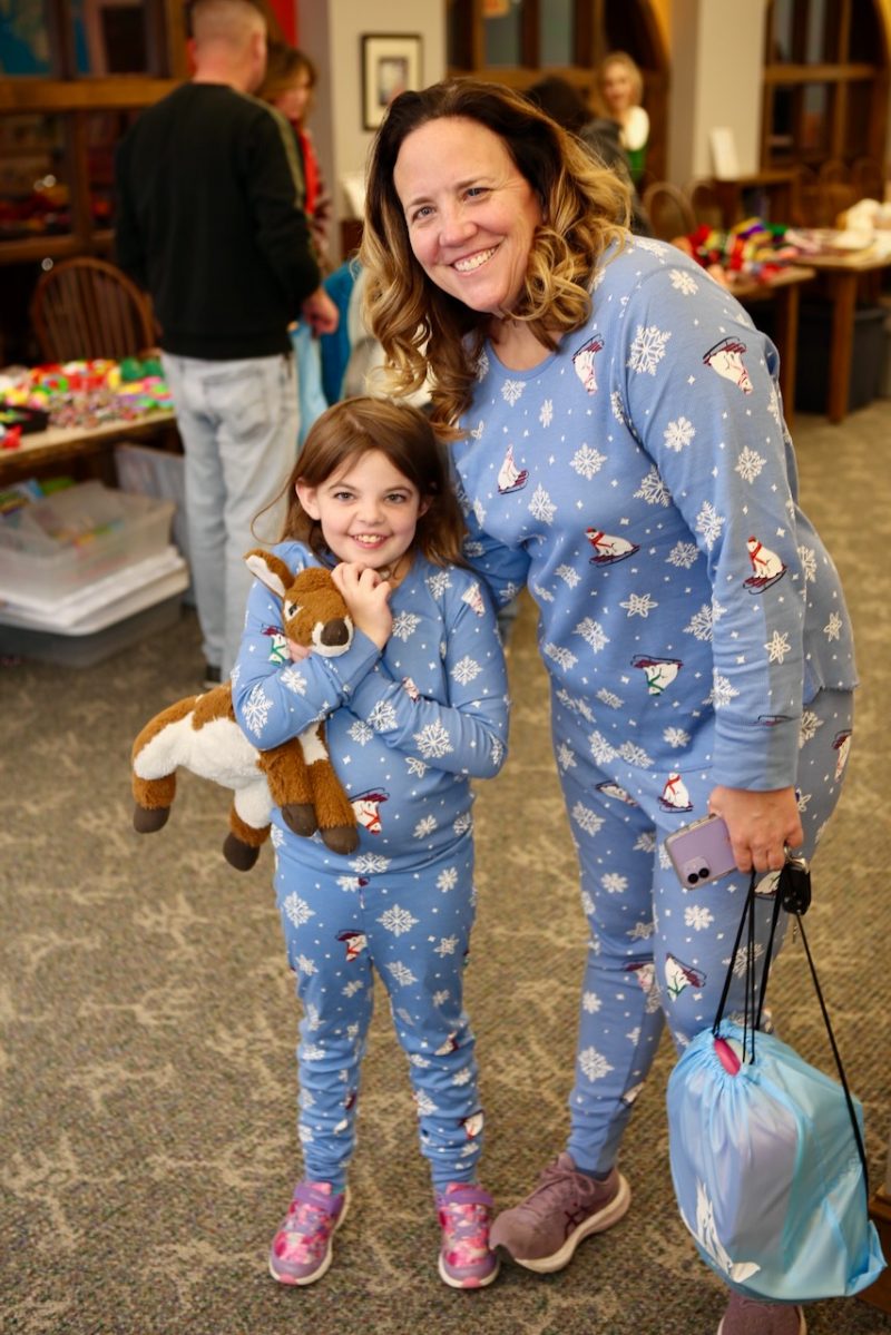 A mother and daughter in matching snowflake pajamas